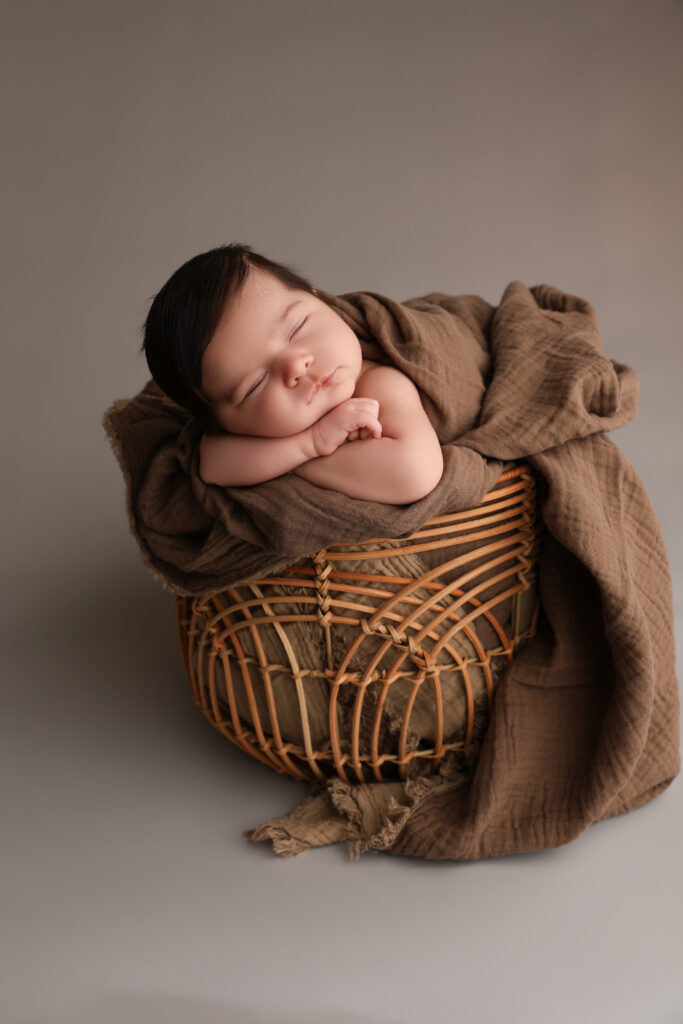 Sovande nyfödd bebis i korg